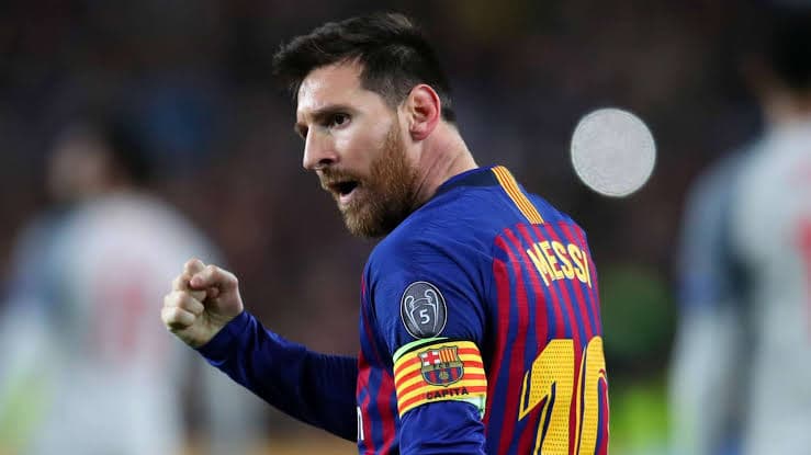 Lionel Messi holding the Ballon d'Or